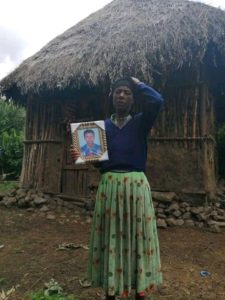 Picture of Gadissa’s mother, Mrs. Mulu, holding her dead son’s picture 
